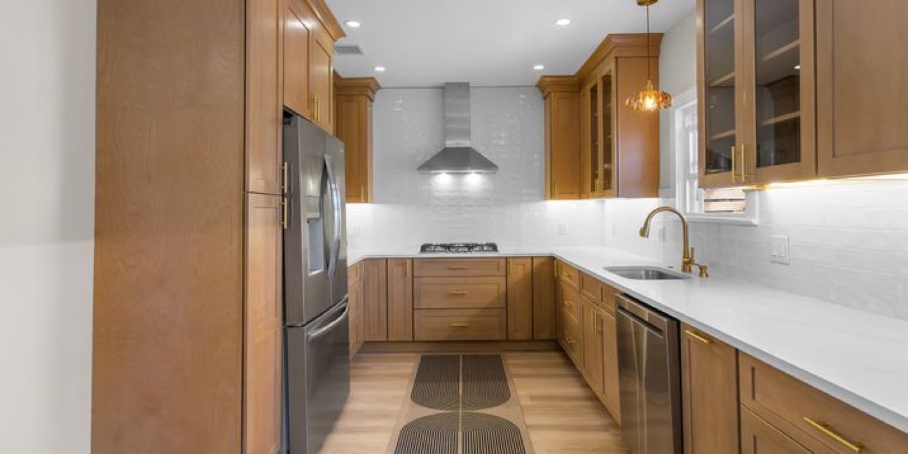 A warm transitional kitchen with a custom, built-in look